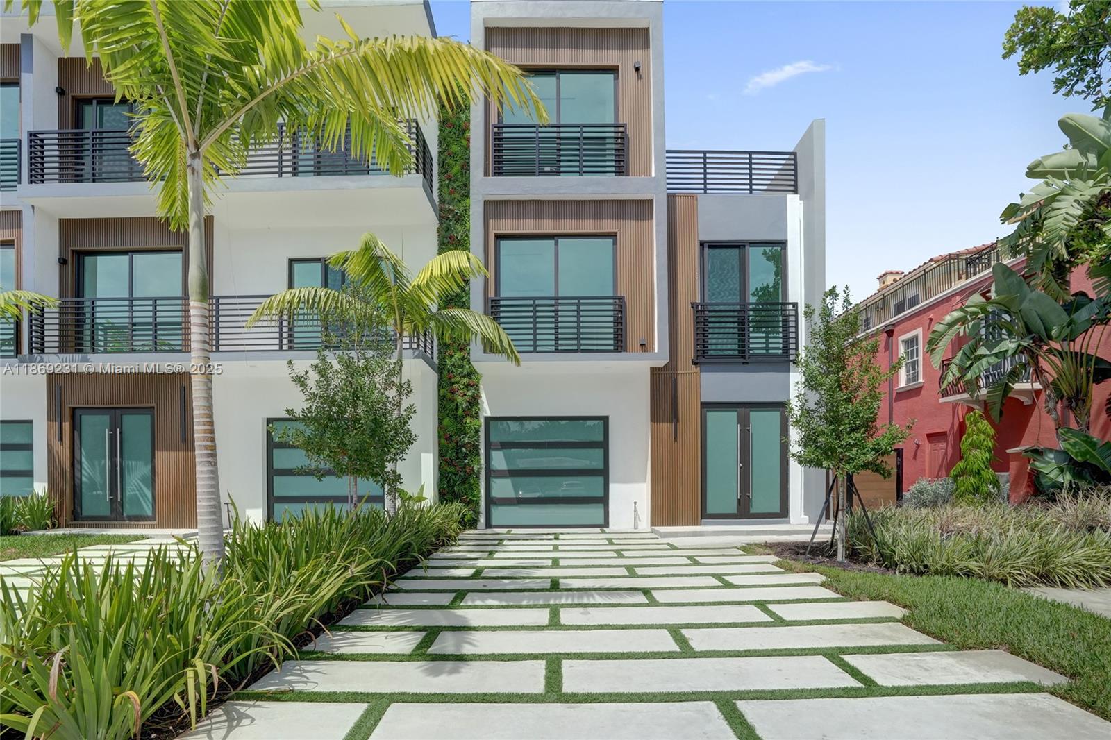 1825 Northeast 26th Avenue, Unit C Fort Lauderdale, FL 33305 - Photo 17 of 90 a front view of a house with a garden