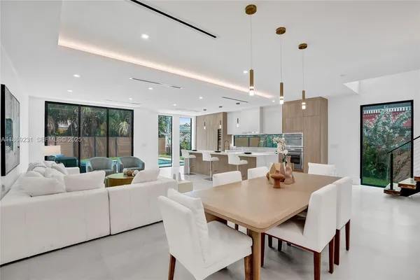 a kitchen with granite countertop a stove and white cabinets
