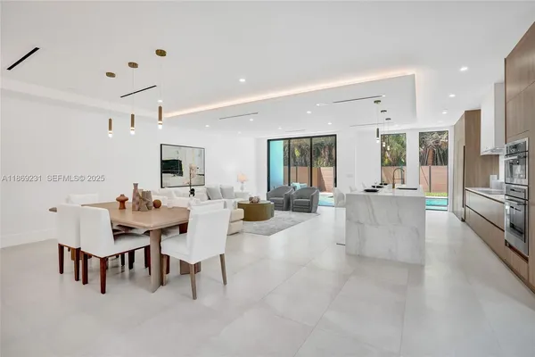 a kitchen with stainless steel appliances kitchen island granite countertop a sink and cabinets