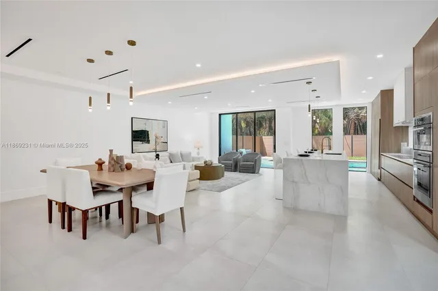 a kitchen with granite countertop a stove and white cabinets