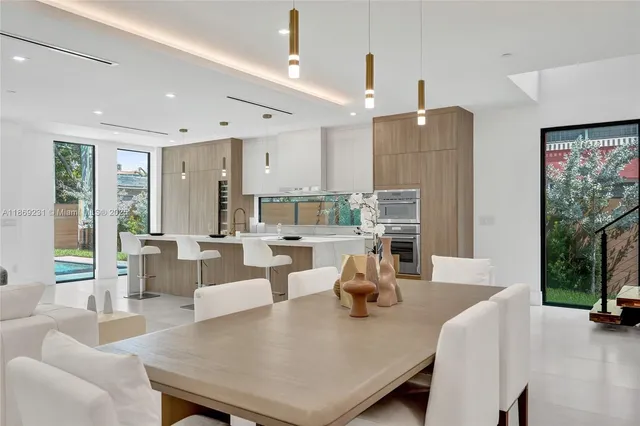 a dining room with furniture and wooden floor