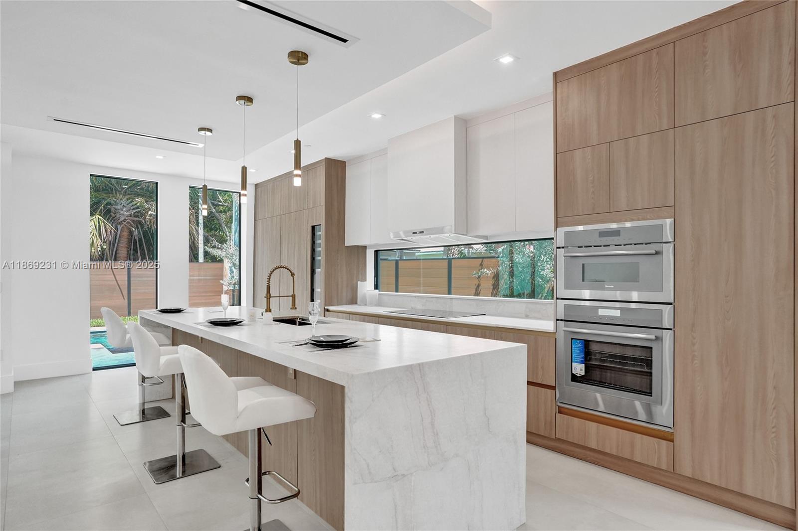1825 Northeast 26th Avenue, Unit C Fort Lauderdale, FL 33305 - Photo 24 of 90 a kitchen with stainless steel appliances granite countertop a stove and a sink