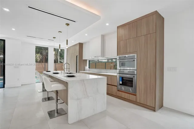 a living room with furniture and stairs