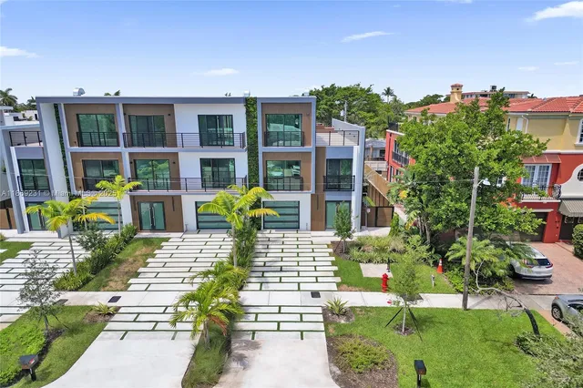 an aerial view of residential houses with city view