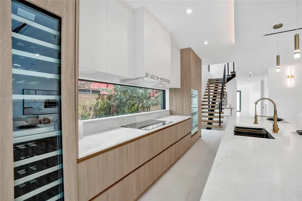 a bathroom with a granite countertop sink a toilet and shower