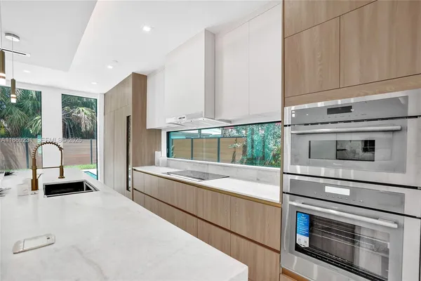 a living room with furniture and kitchen view