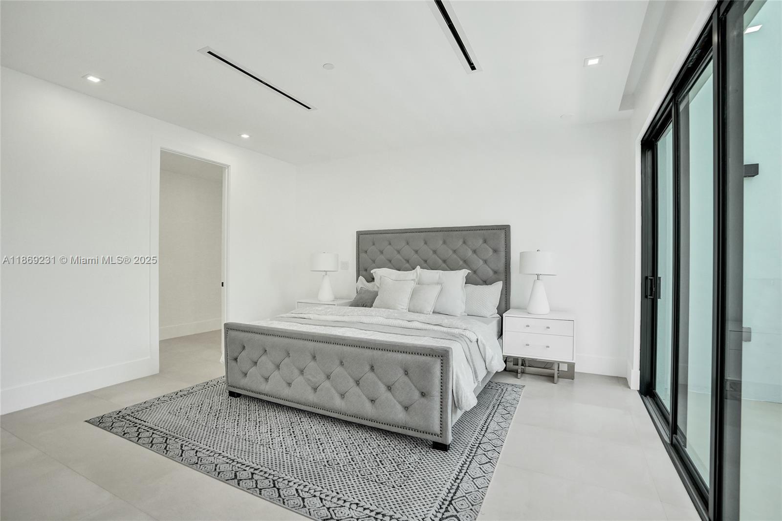 1825 Northeast 26th Avenue, Unit C Fort Lauderdale, FL 33305 - Photo 50 of 90 a room with a bed and a rug