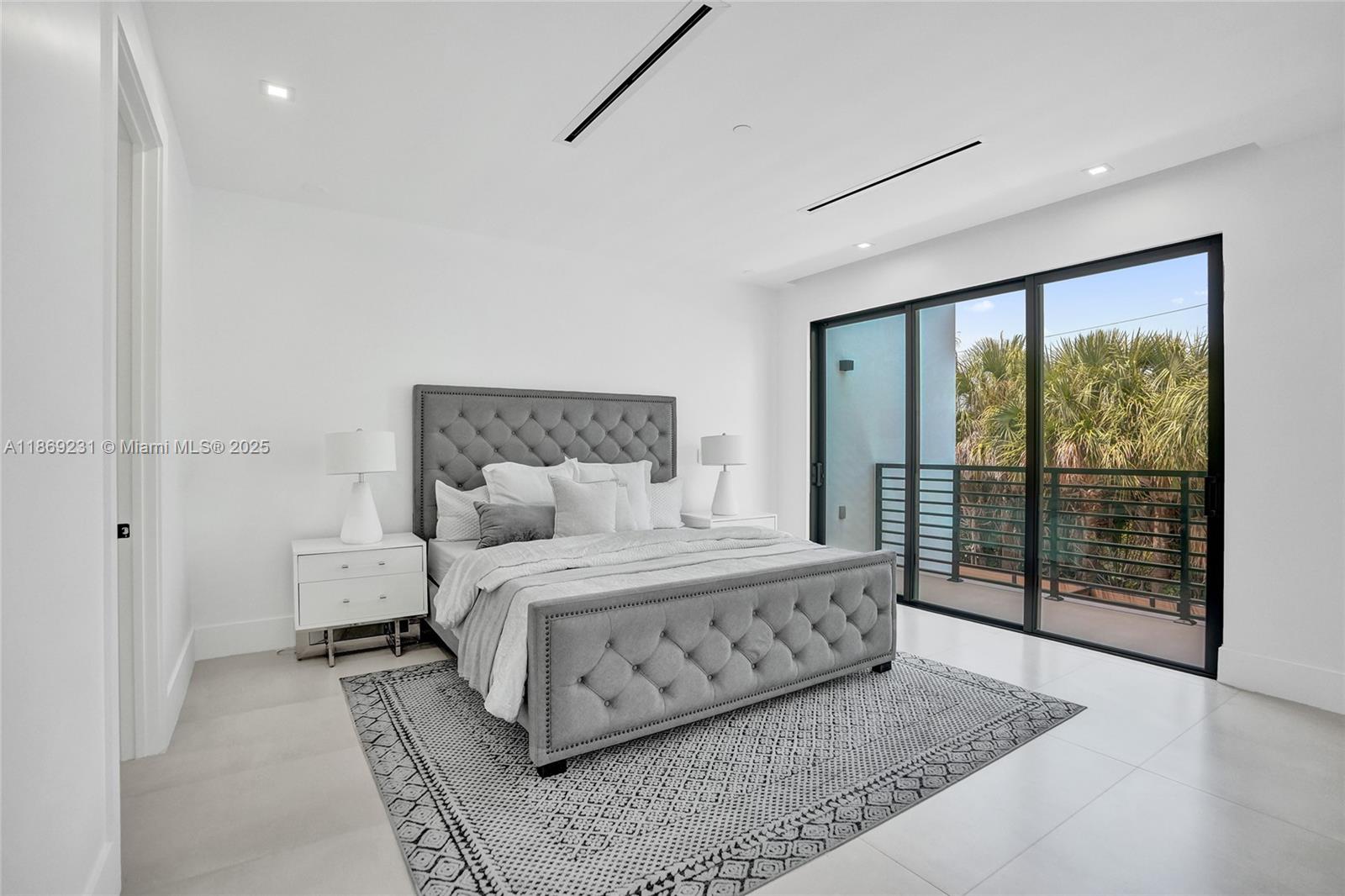 1825 Northeast 26th Avenue, Unit C Fort Lauderdale, FL 33305 - Photo 51 of 90 a bedroom with a large bed and a large window