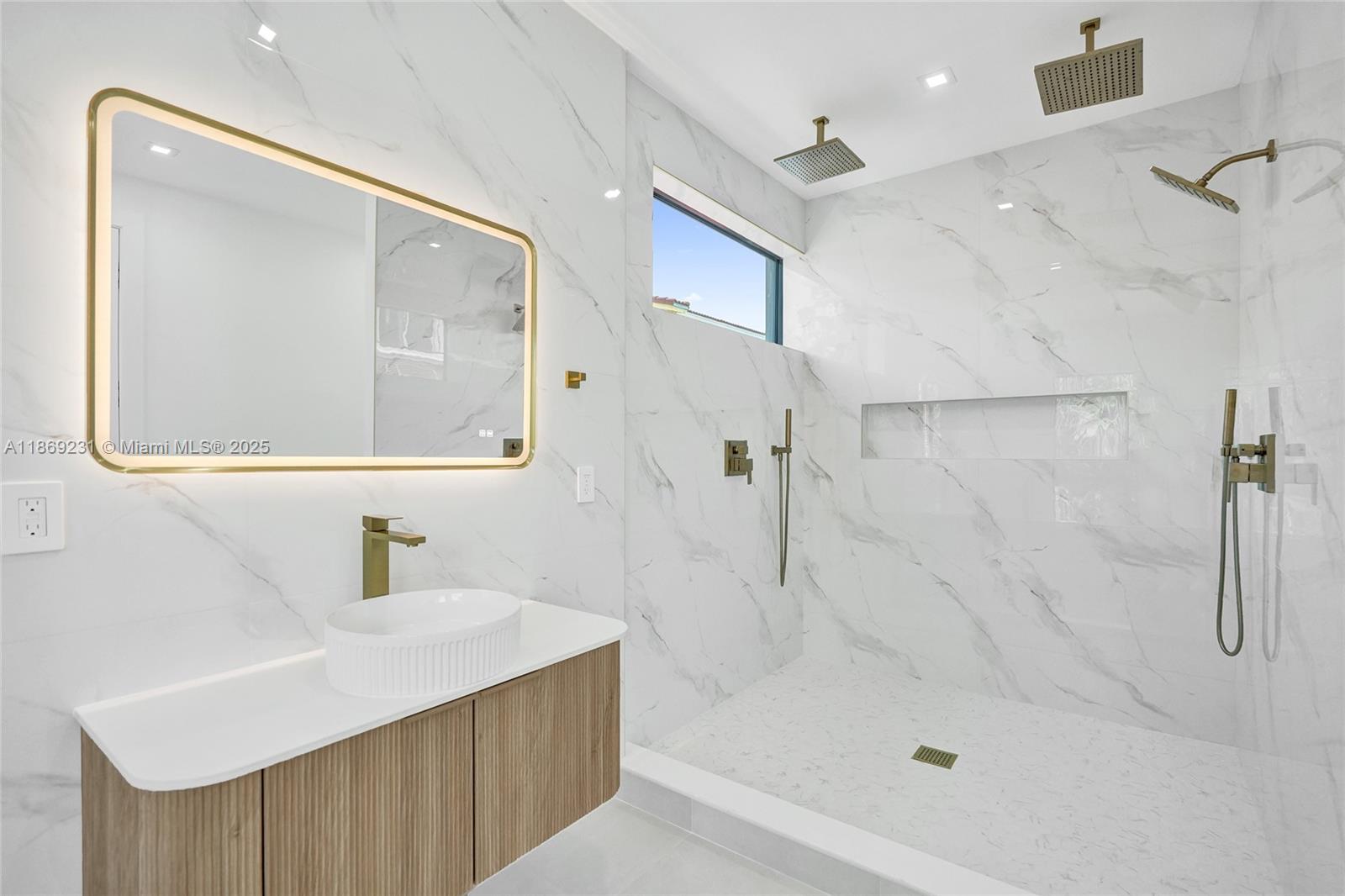 1825 Northeast 26th Avenue, Unit C Fort Lauderdale, FL 33305 - Photo 56 of 90 a bathroom with a sink a mirror a shower and vanity