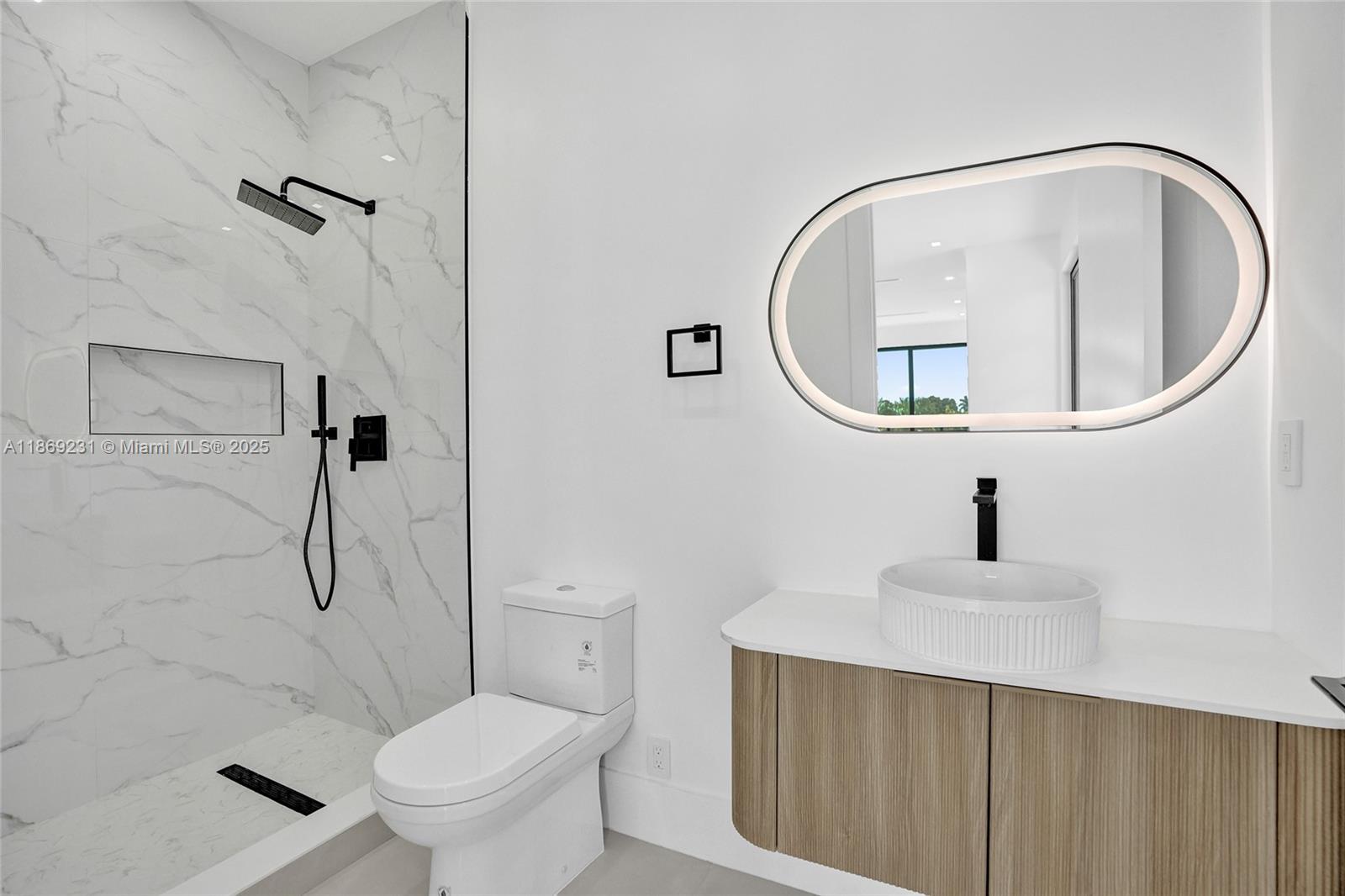 1825 Northeast 26th Avenue, Unit C Fort Lauderdale, FL 33305 - Photo 59 of 90 a bathroom with a toilet sink vanity and shower