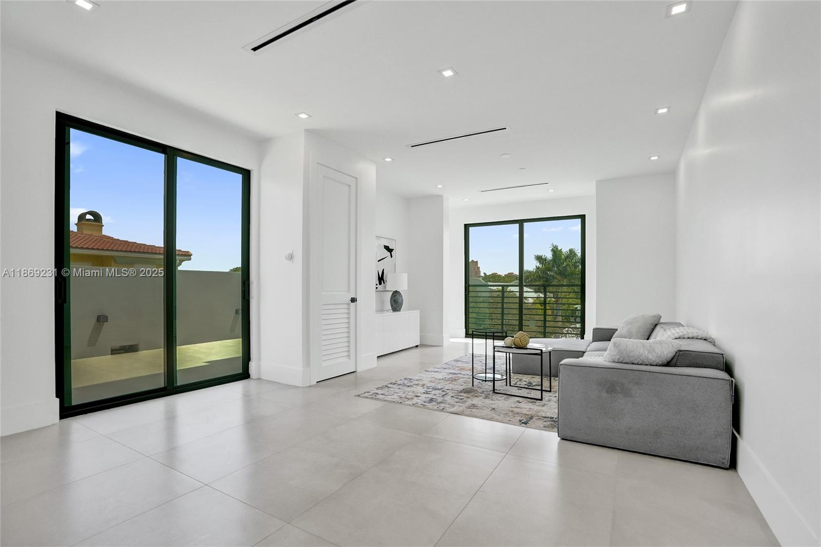 1825 Northeast 26th Avenue, Unit C Fort Lauderdale, FL 33305 - Photo 64 of 90 a living room with furniture and a large window