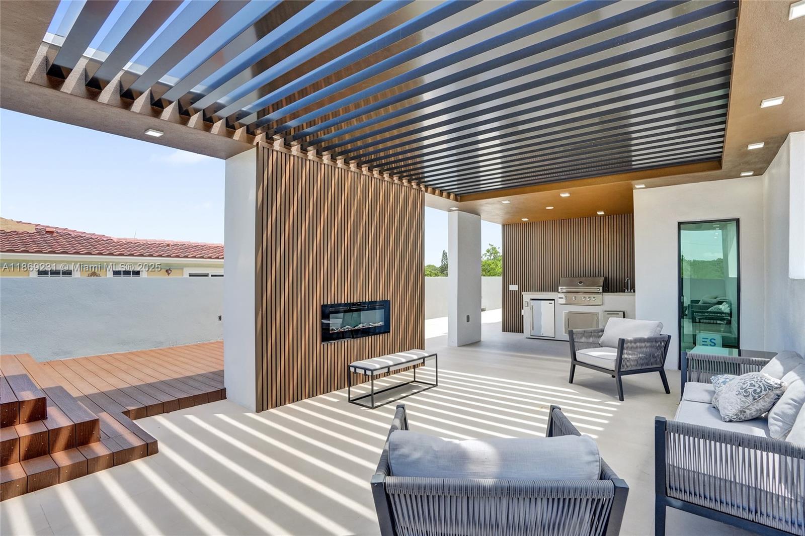 1825 Northeast 26th Avenue, Unit C Fort Lauderdale, FL 33305 - Photo 74 of 90 a outdoor space with patio couches and a fireplace