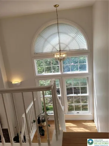 a view of an entryway with a floor to ceiling window