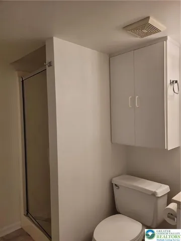 a white toilet sitting next to a bathroom sink