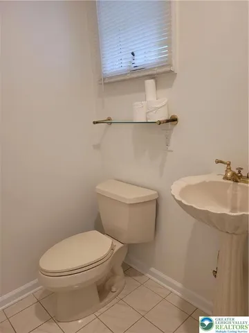 a white toilet sitting next to a bathroom sink