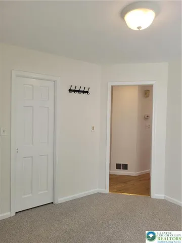 an empty room with closet area
