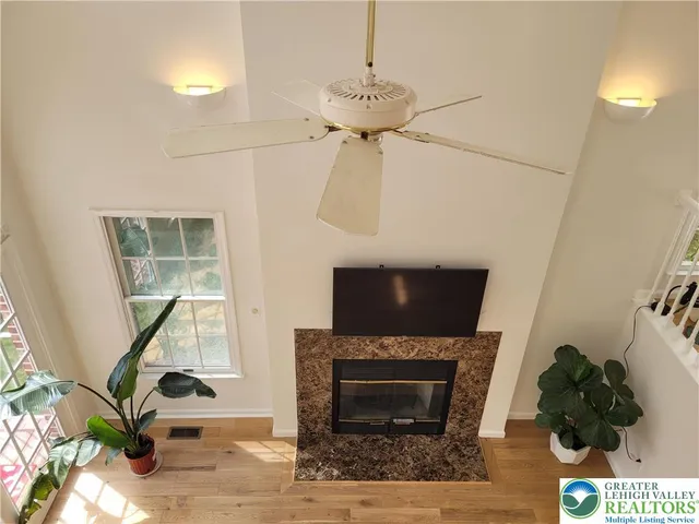 a living room with a fireplace and a potted plant