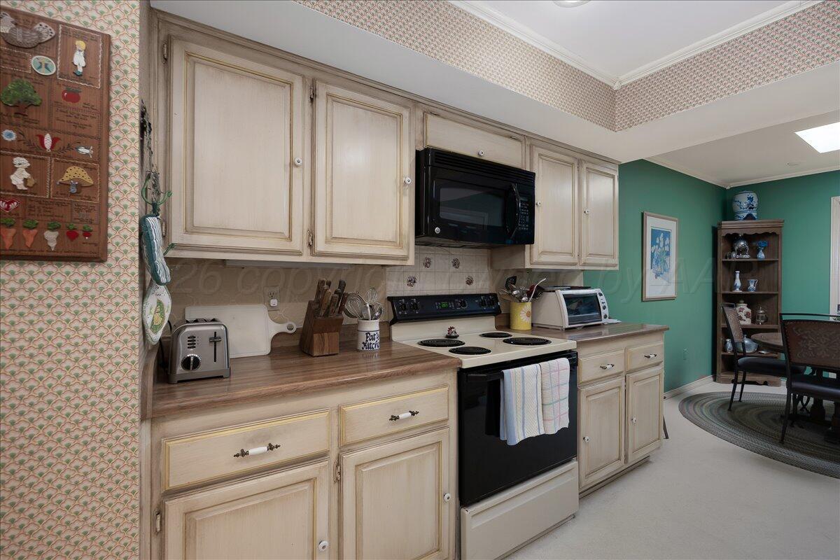 1615 South Bryan Street, Unit 1 Amarillo, TX 79102 - Photo 13 of 30 a kitchen with stainless steel appliances granite countertop a sink and a stove