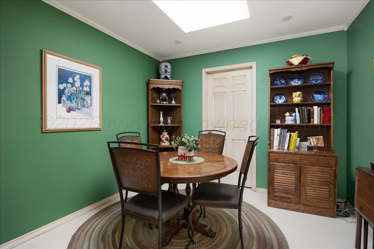 1615 South Bryan Street, Unit 1 Amarillo, TX 79102 - Photo 15 of 30 a view of a dining room with furniture and a book shelf