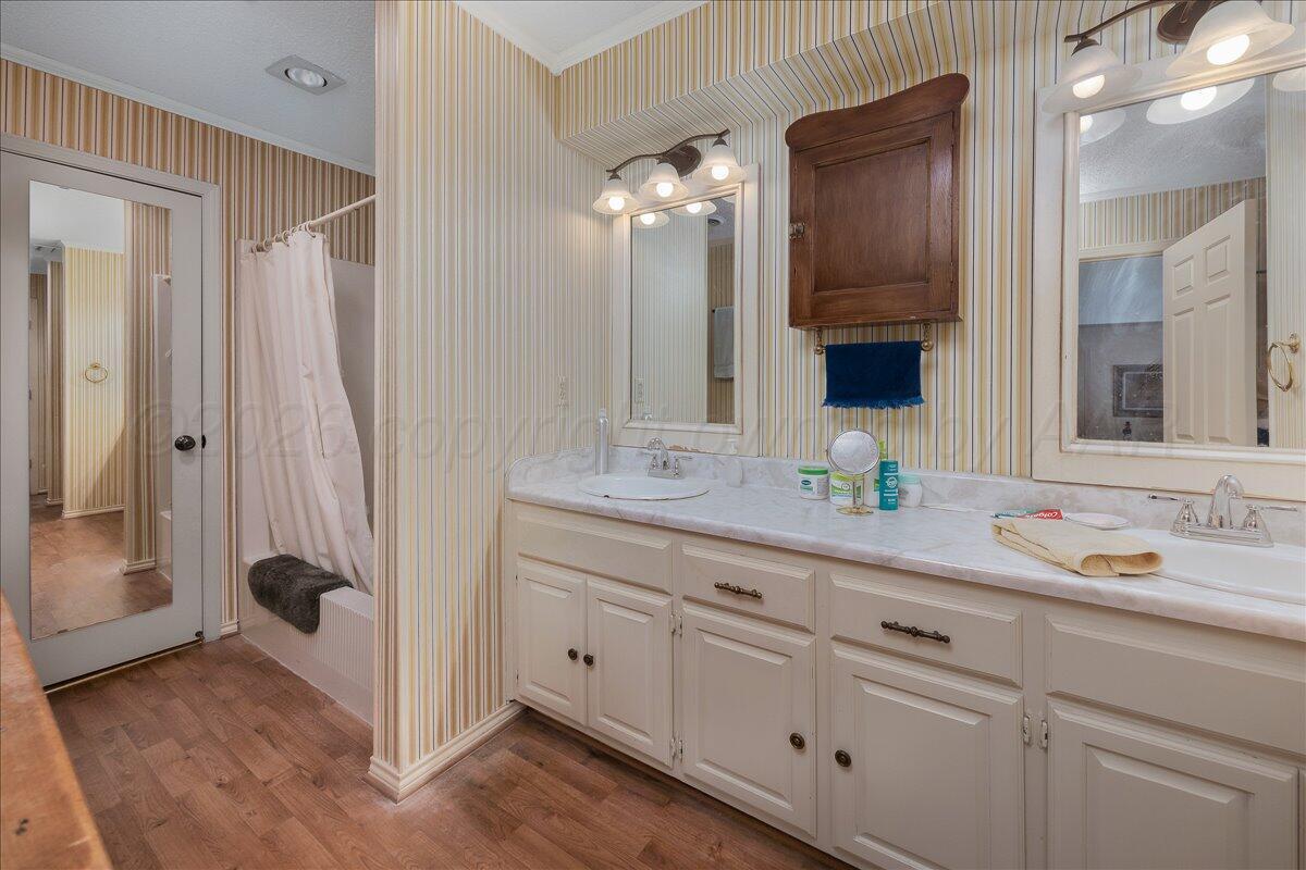 1615 South Bryan Street, Unit 1 Amarillo, TX 79102 - Photo 19 of 30 a bathroom with a granite countertop sink mirror and double