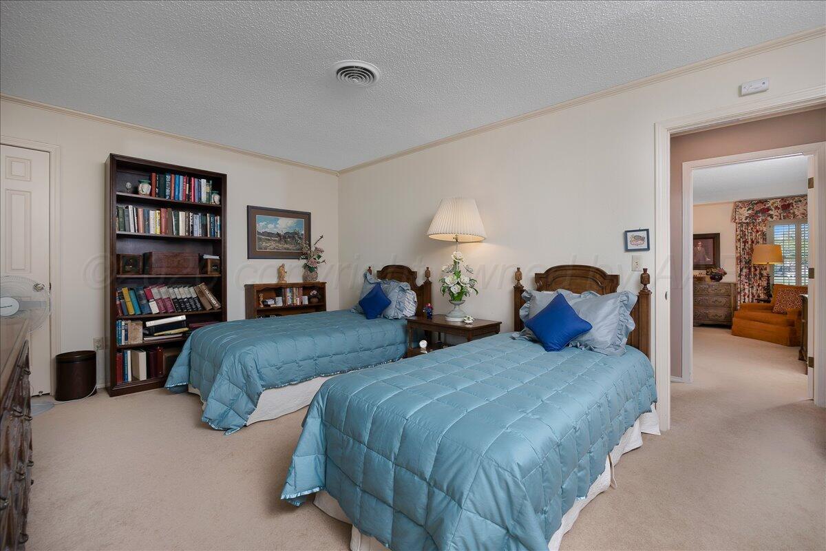 1615 South Bryan Street, Unit 1 Amarillo, TX 79102 - Photo 21 of 30 a bedroom with bed and a book shelf