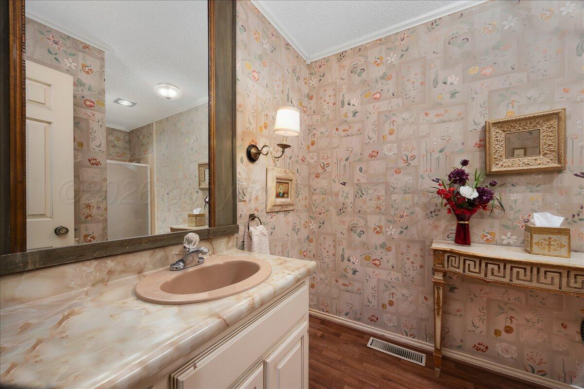 1615 South Bryan Street, Unit 1 Amarillo, TX 79102 - Photo 26 of 30 a bathroom with a sink and a mirror