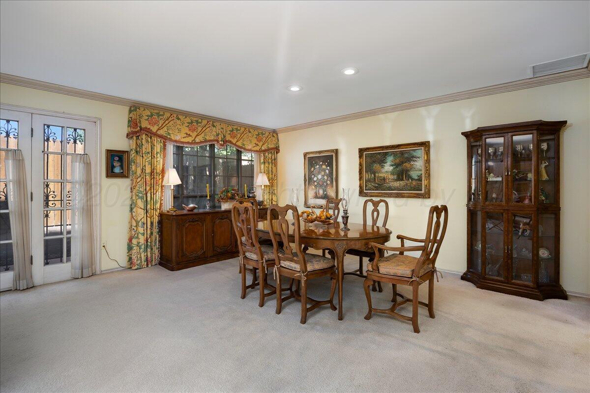 1615 South Bryan Street, Unit 1 Amarillo, TX 79102 - Photo 9 of 30 a view of a dining room with furniture and chandelier