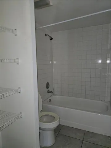 a bath room with a toilet and a bath tub