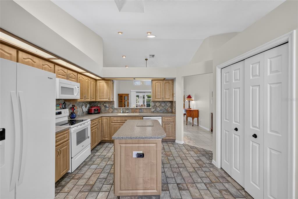 19025 Southwest 98th Loop Dunnellon, FL 34432 - Photo 24 of 80 a kitchen with white cabinets and counter space