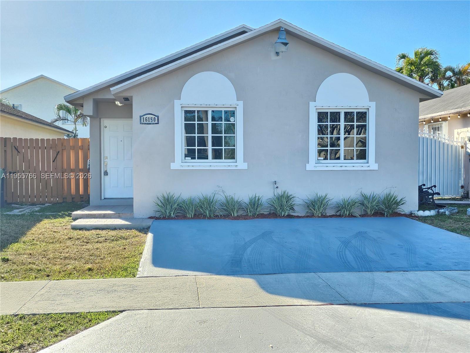 16150 Southwest 138th Court Miami, FL 33177 - Photo 1 of 10 a front view of a house with garden