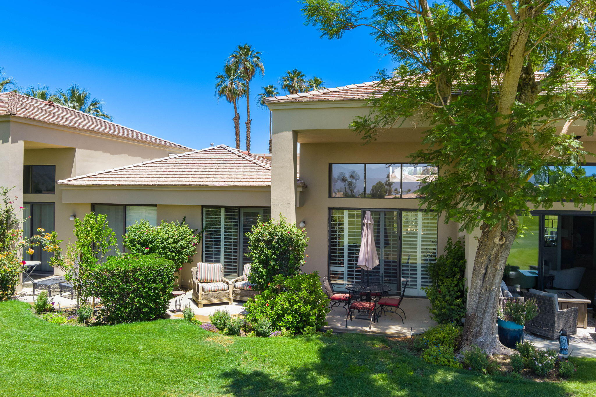 80601 Oak-Tree La Quinta, CA 92253 - Photo 12 of 64 a front view of a house with garden