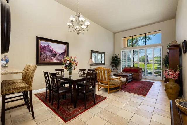 a view of a dining room with furniture and chandelier