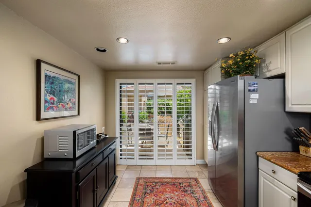a kitchen with a refrigerator and a sink