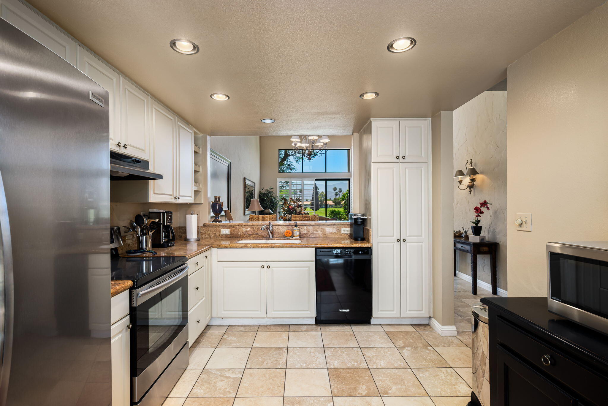 80601 Oak-Tree La Quinta, CA 92253 - Photo 25 of 64 a kitchen with stainless steel appliances kitchen island granite countertop a refrigerator and a stove top oven