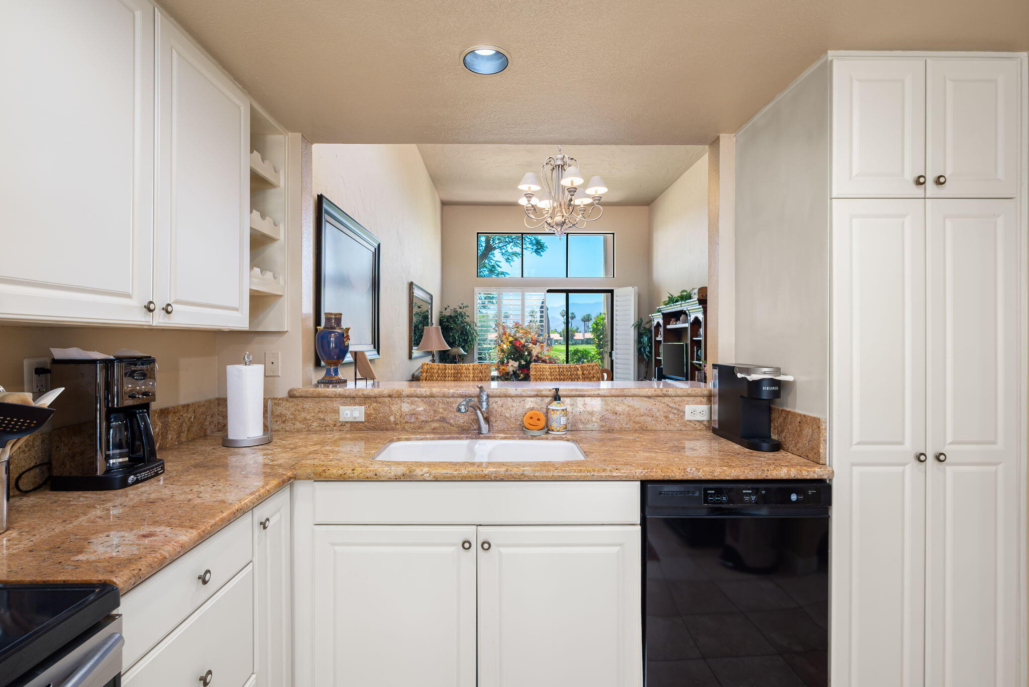 80601 Oak-Tree La Quinta, CA 92253 - Photo 26 of 64 a kitchen with sink cabinets and appliances