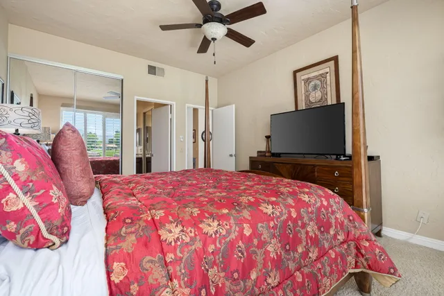 a bed room with a bed and a tv