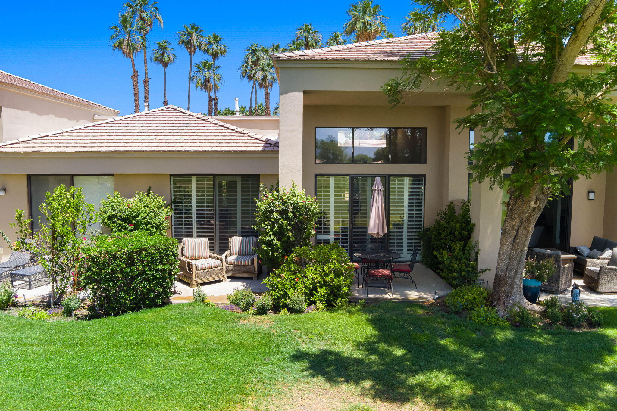 80601 Oak-Tree La Quinta, CA 92253 - Photo 3 of 64 a front view of a house with garden