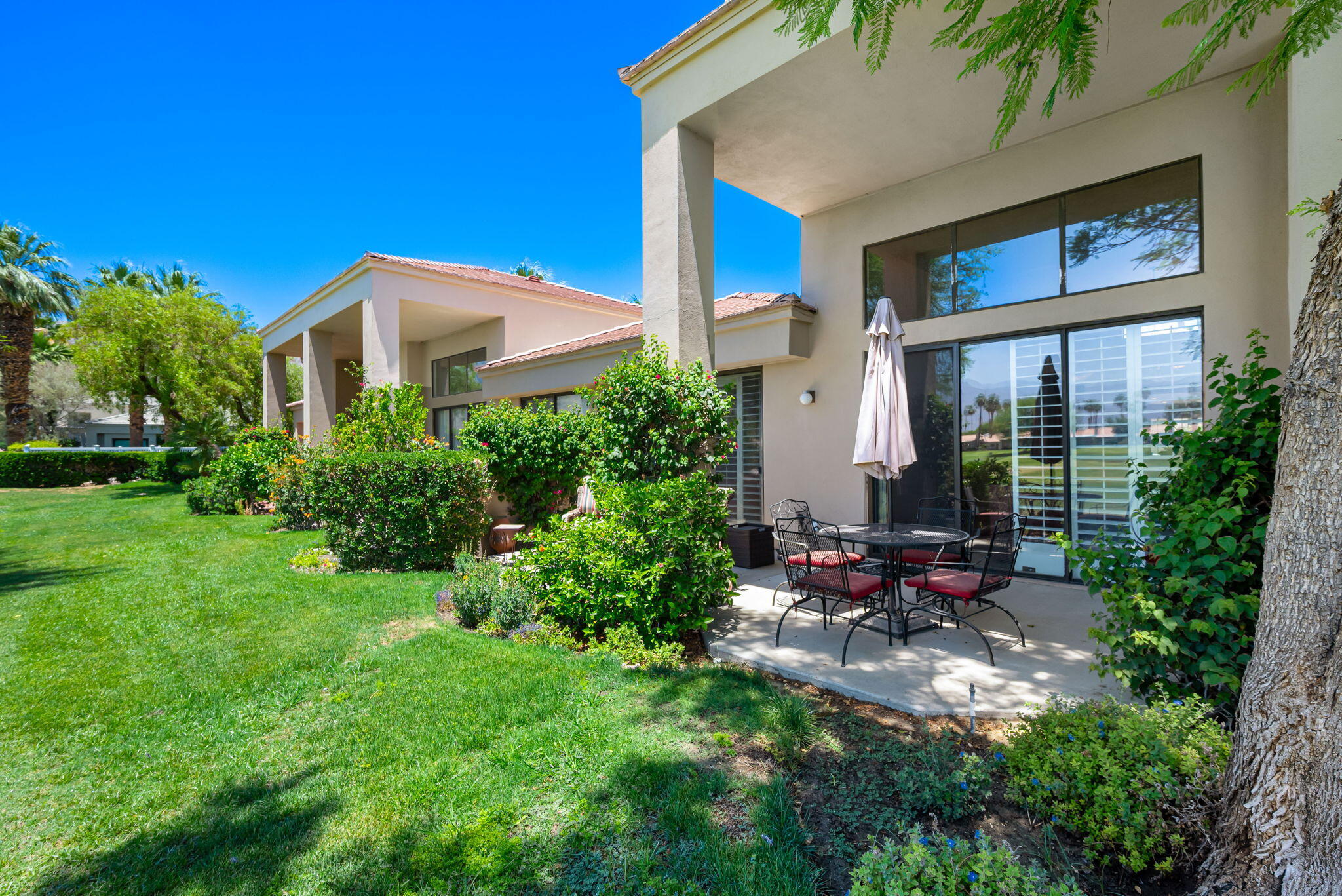 80601 Oak-Tree La Quinta, CA 92253 - Photo 39 of 64 a view of a house with backyard sitting area and garden