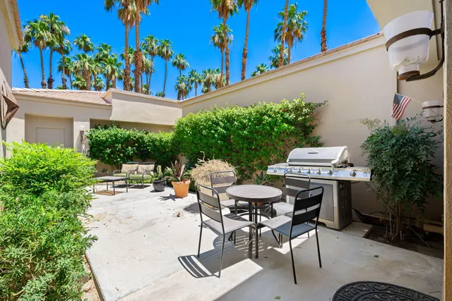a view of a backyard with plants and a patio
