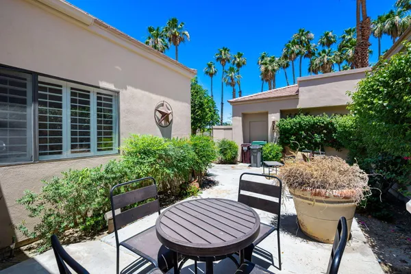 a view of backyard with outdoor seating and plants