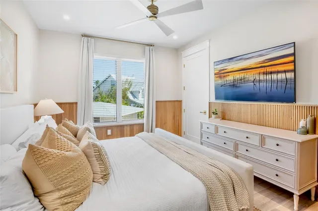 a view of a bedroom with wooden floor and cabinet