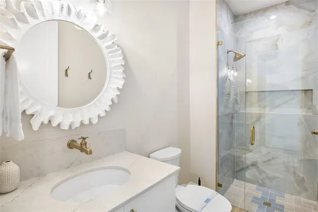 a bed room with a bed and a chair