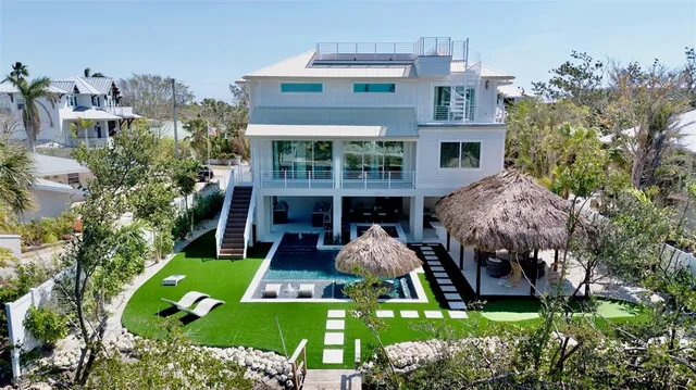 an aerial view of a city with lots of residential buildings ocean and mountain view in back
