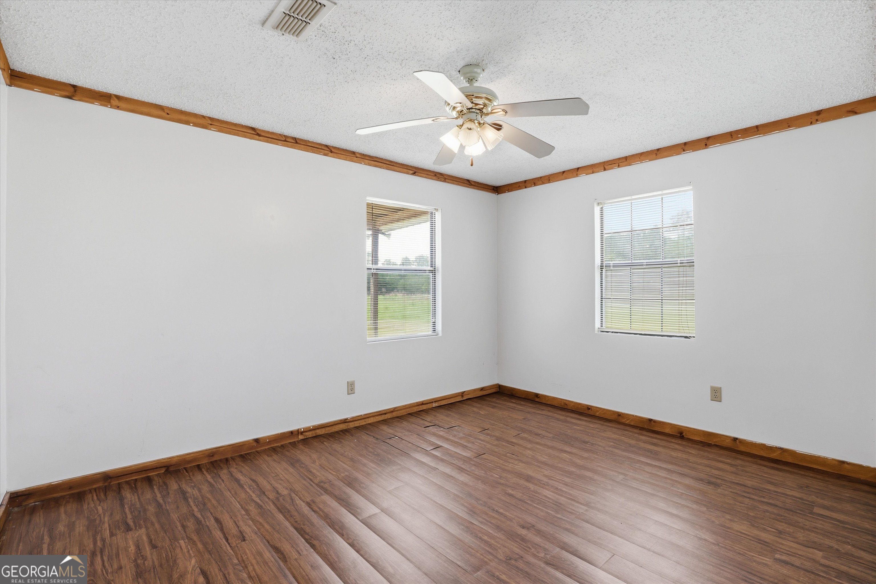 1525 Myron Hart Road Coolidge, GA 31738 - Photo 25 of 58 a view of an empty room with wooden floor and a window