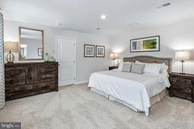 a bedroom with a bed and a dresser