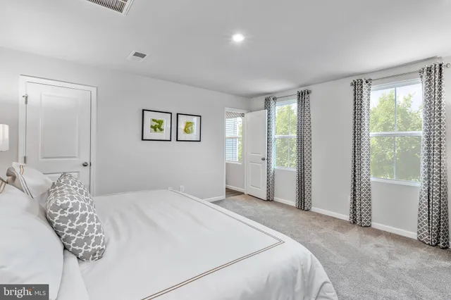 a bedroom with a large bed and a window