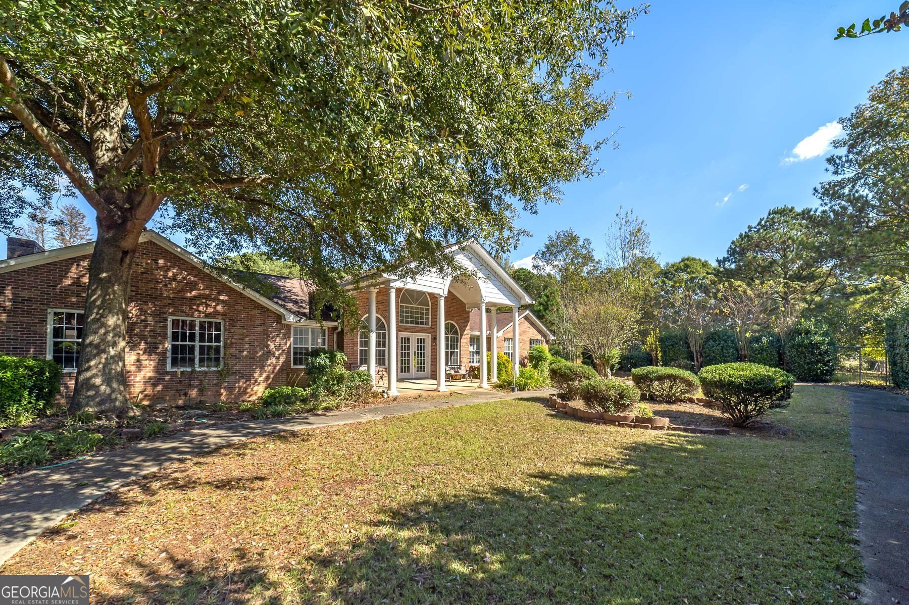 3084 Highway 81 Hampton, GA 30228 - Photo 6 of 57 a front view of a house with a garden