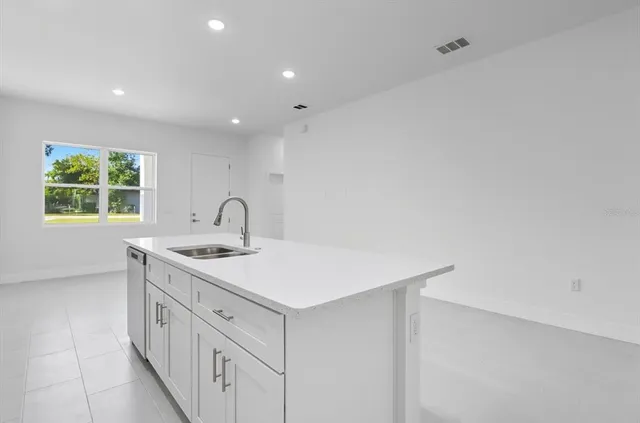 a kitchen with refrigerator cabinets and furniture
