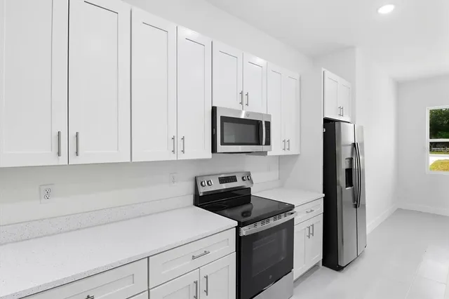 a kitchen with stainless steel appliances a refrigerator sink and stove