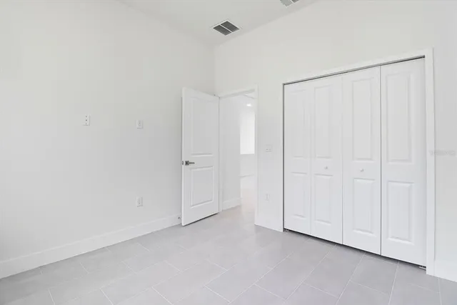 a bathroom with a granite countertop toilet sink and mirror